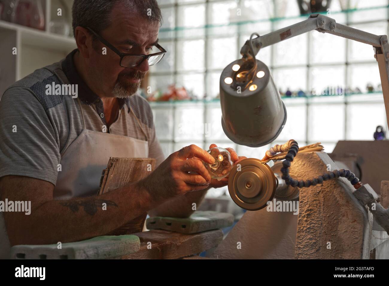 A craftsman working in the Sculpting Department at the Waterford Crystal factory, in the city of Waterford, Republic of Ireland. Stock Photo