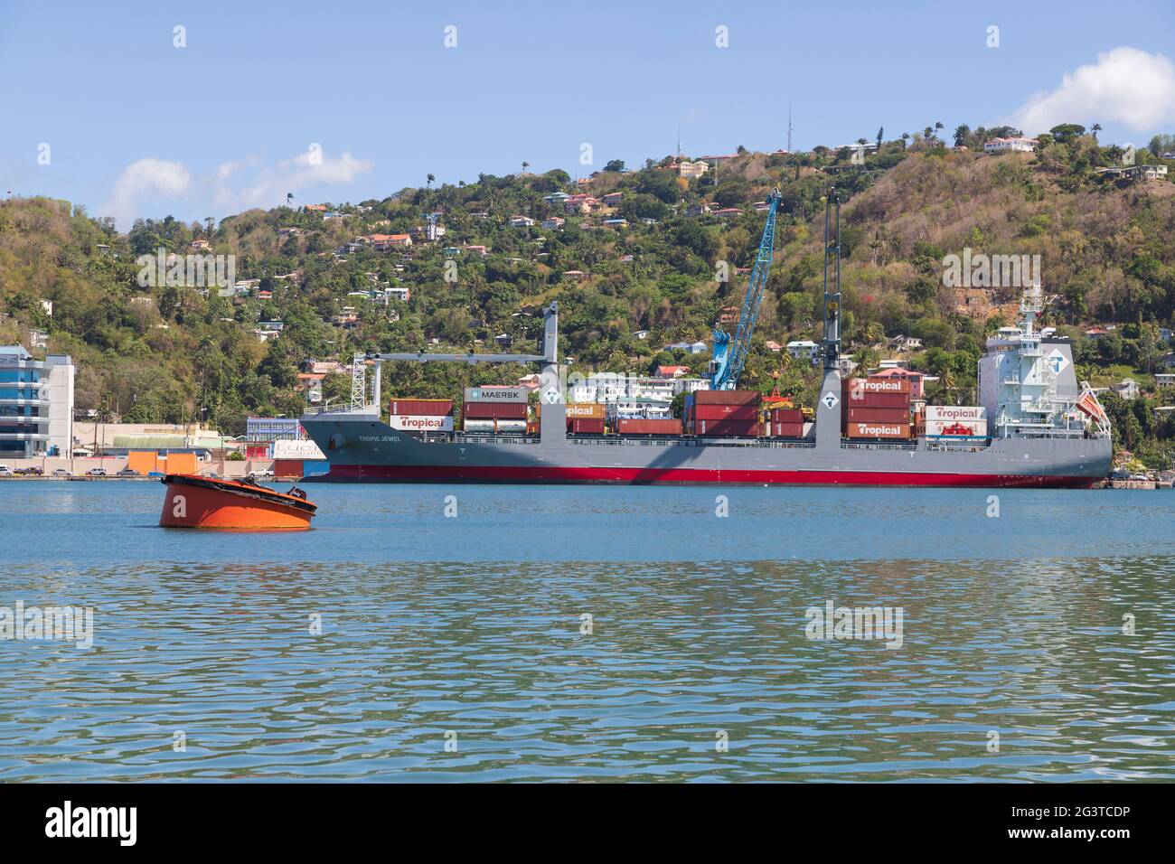 Cargo ship in port being offloaded Stock Photo
