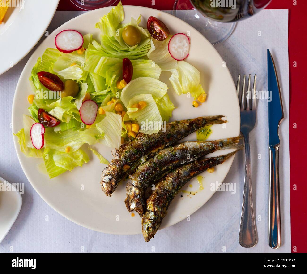 Fried sardines with vegetable salad Stock Photo