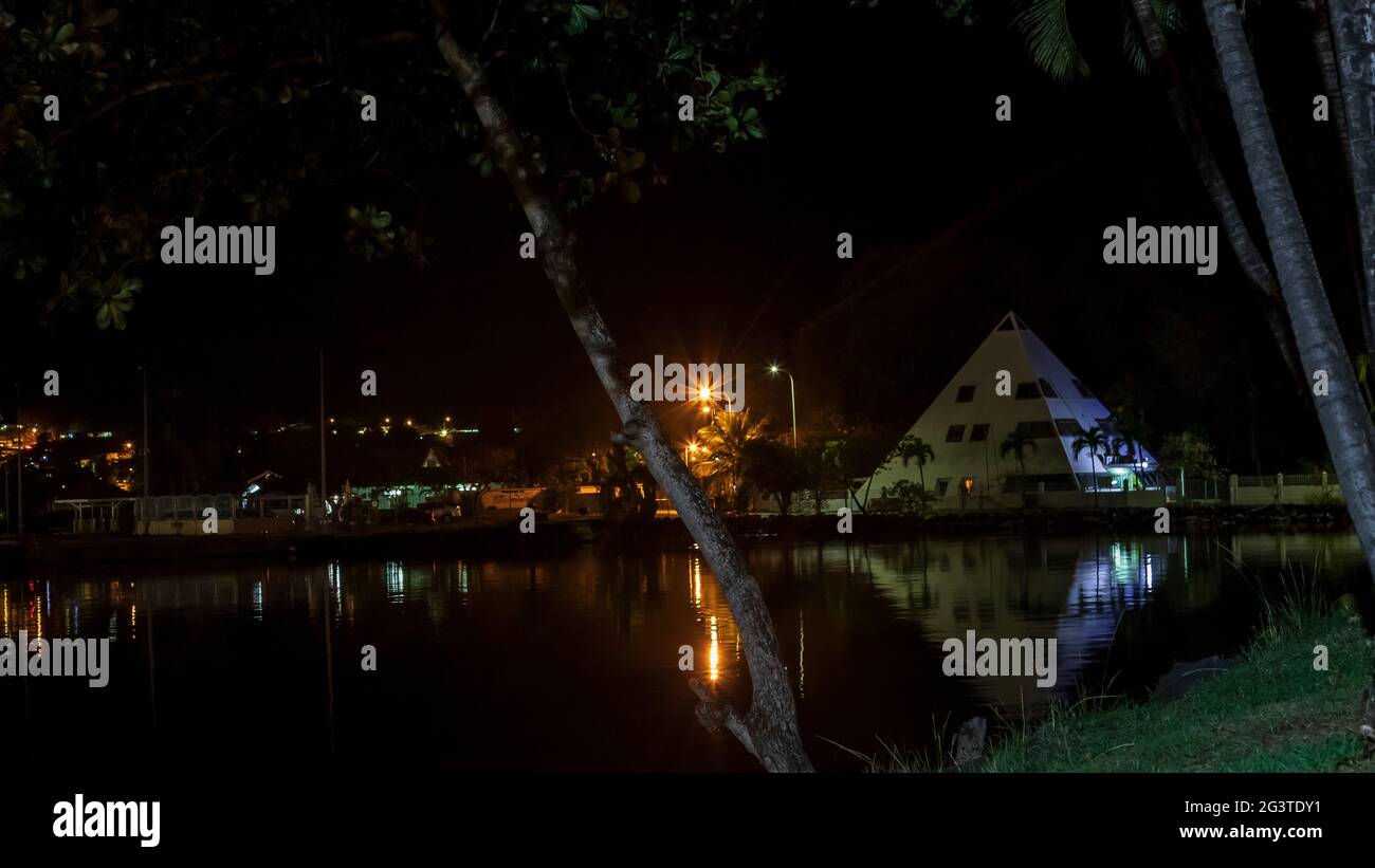 Castries harbor at night with a view of the Alliance Francais building- the white pyramid Stock Photo