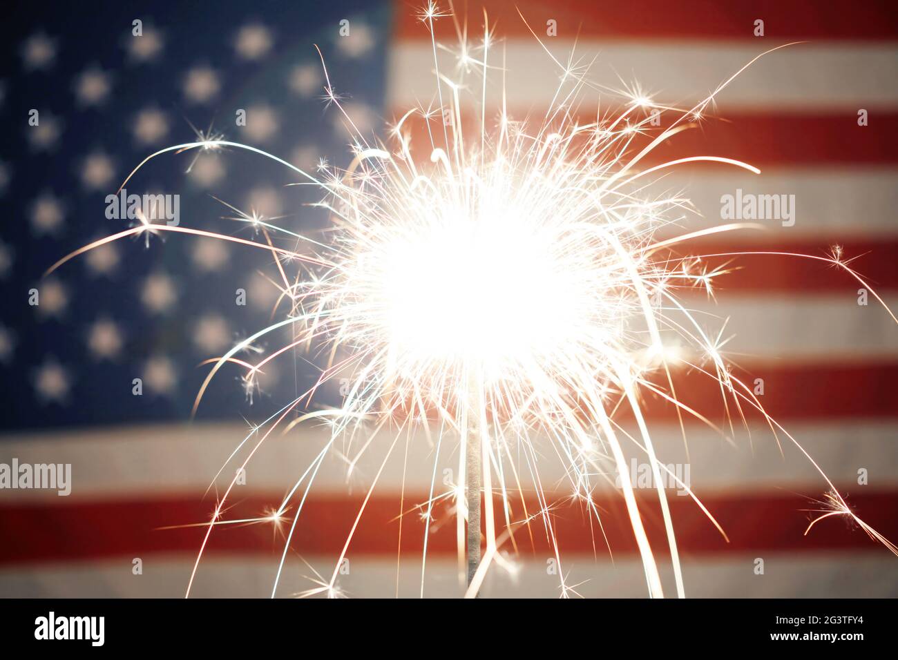 Lit sparkler burning in front of American Flag Stock Photo - Alamy