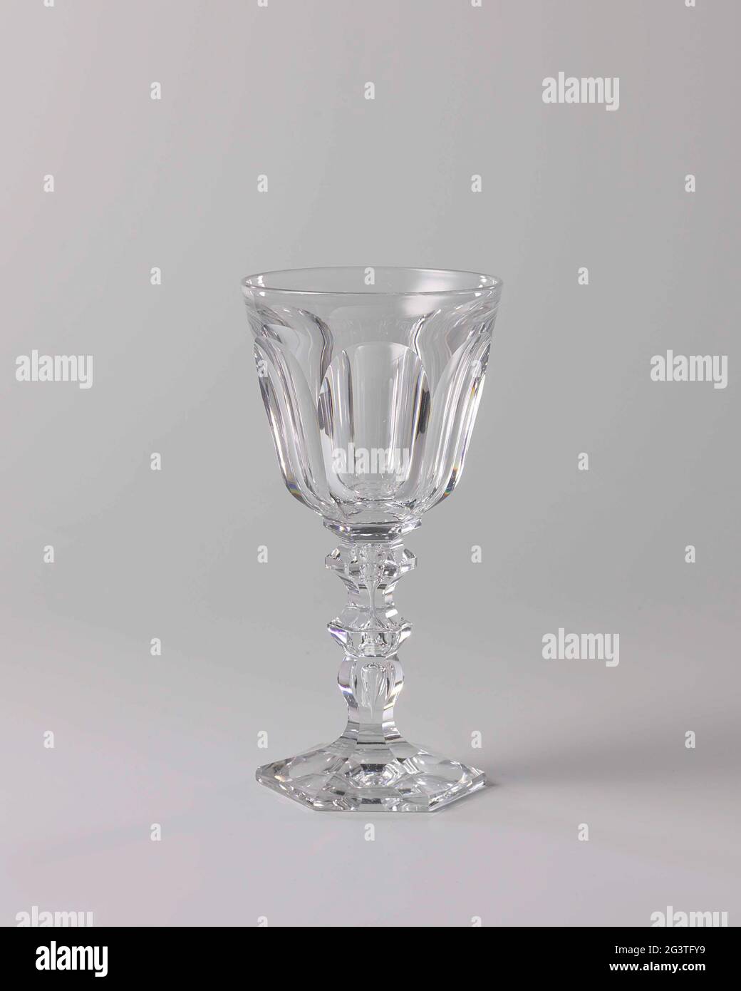 Kelkglas with cut elips. Hexagonal, conical foot, baluster-shaped strain with an embedded air bubble and two buttons. Conical, rugged on the bottom. Facet cut foot and trunk, chalice in ellipsen ground. Stock Photo