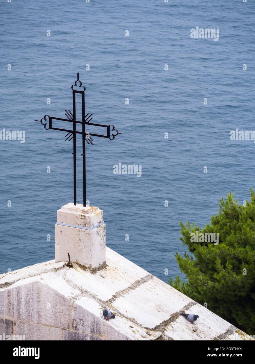Religious cross on top of a church at rovinj Stock Photo
