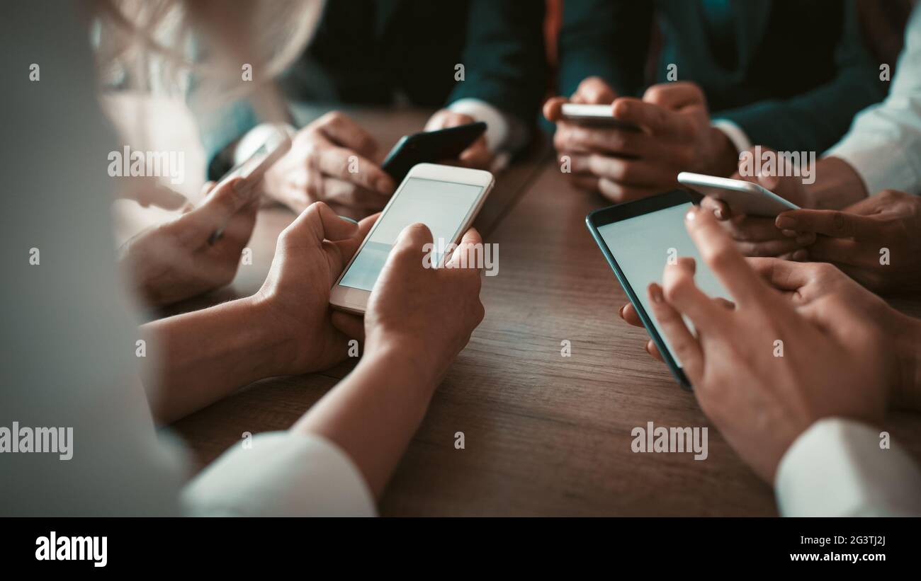 Team of app developers testing the bugs of the new app while testing usability with different operation system gadgets. Business Stock Photo
