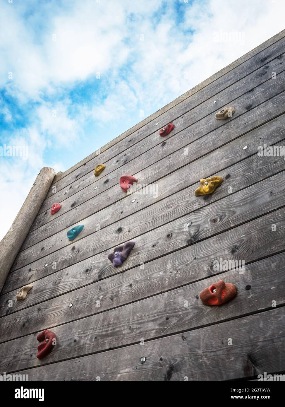 Rock climbing wall with blue sky Stock Photo - Alamy