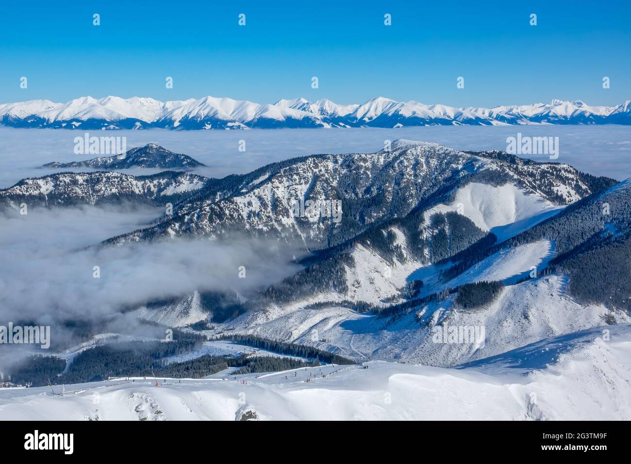 Snow Capped Peaks and Fog in the Valleys. Aerial View Stock Photo - Alamy