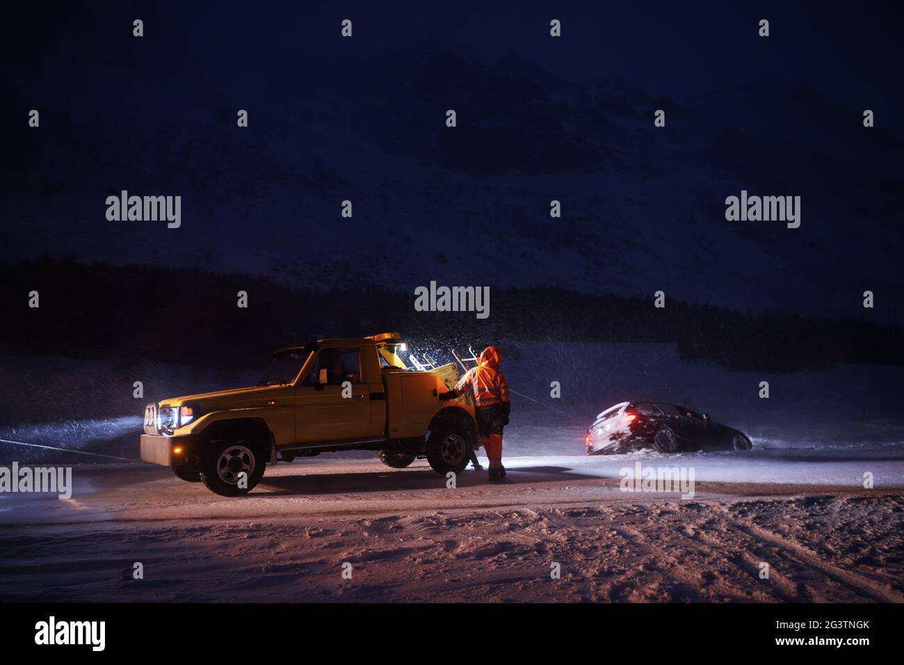 Car being towed after accident in snow storm Stock Photo Alamy