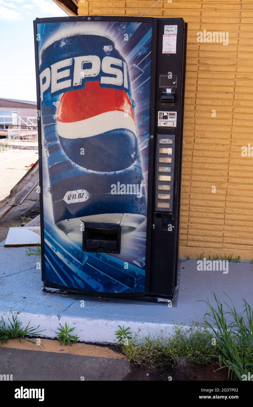 Clinton, Oklahoma - May 6, 2021: Old abandoned Pepsi soda machine sits outside of the abandoned Glancy Motel Stock Photo