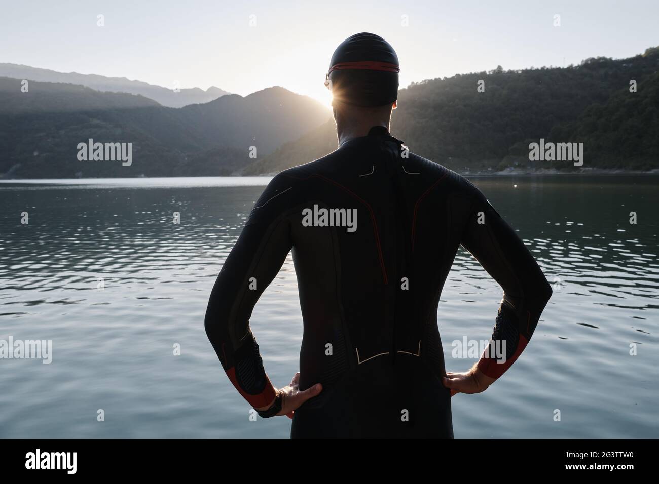 Triathlon athlete starting swimming training on lake Stock Photo Alamy