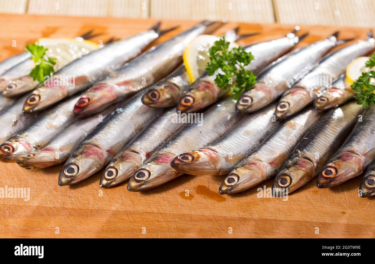 Pickled European anchovies with lemon and greens Stock Photo Alamy