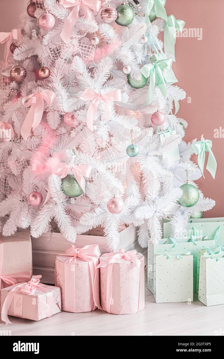 Gift boxes and pastel Christmas tree, wrapped presents and decor in modern  style as holiday home decoration Stock Photo - Alamy
