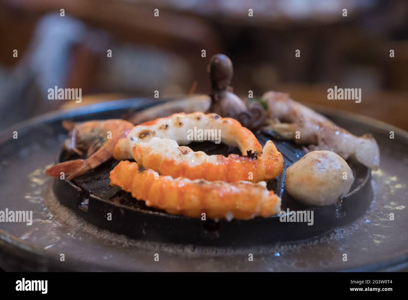 Seafood on steaming and grilling cooker pot Stock Photo
