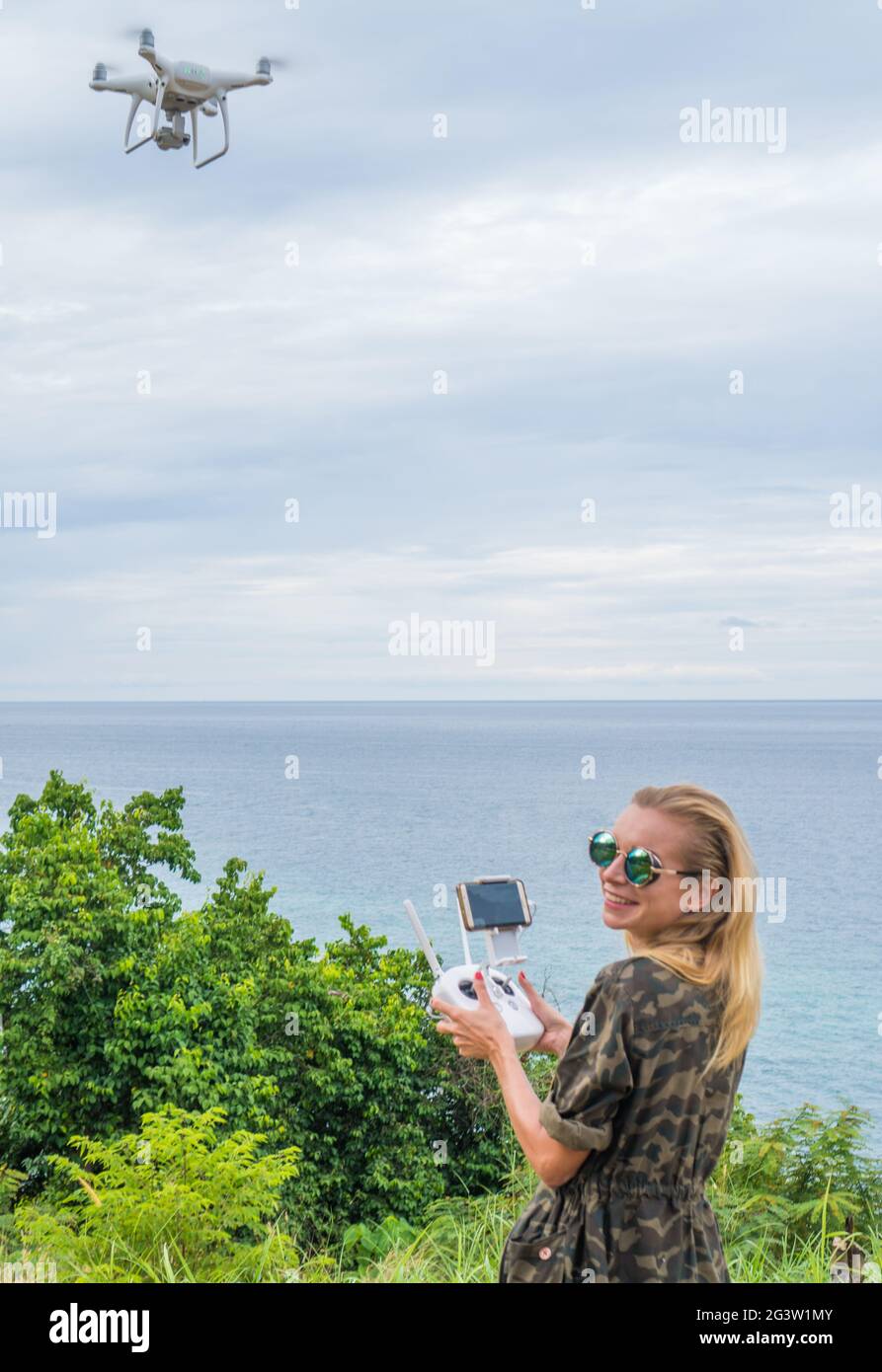 Happy woman taking photos with drone camera Stock Photo