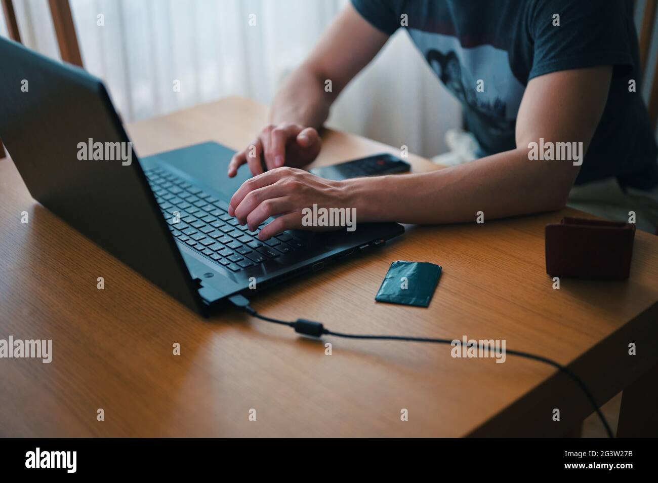 Midsection of man using laptop Stock Photo