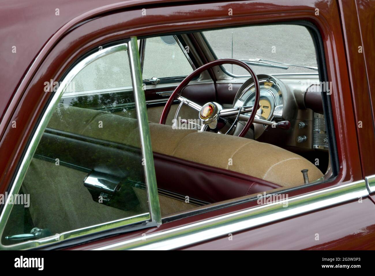 The 1949 Chrysler dashboard is seen through an open rear window. Stock Photo