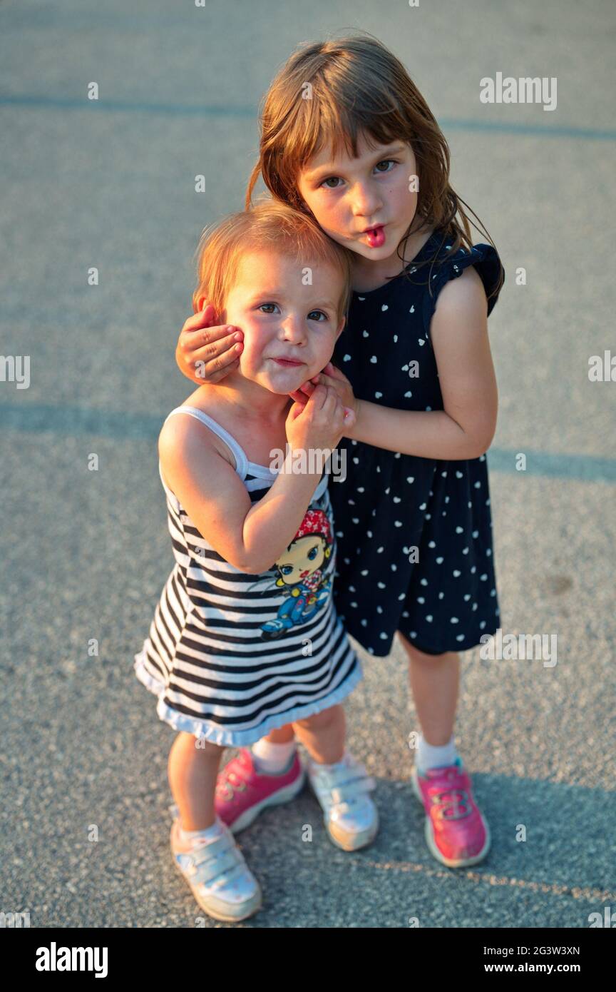 Portrait of two little girls hugging each other Stock Photo
