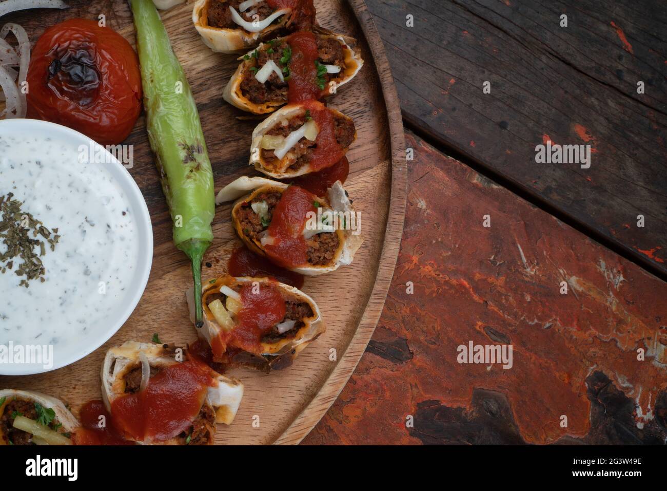Closeup top view of Turkish Beyti kebab served with grilled vegetables