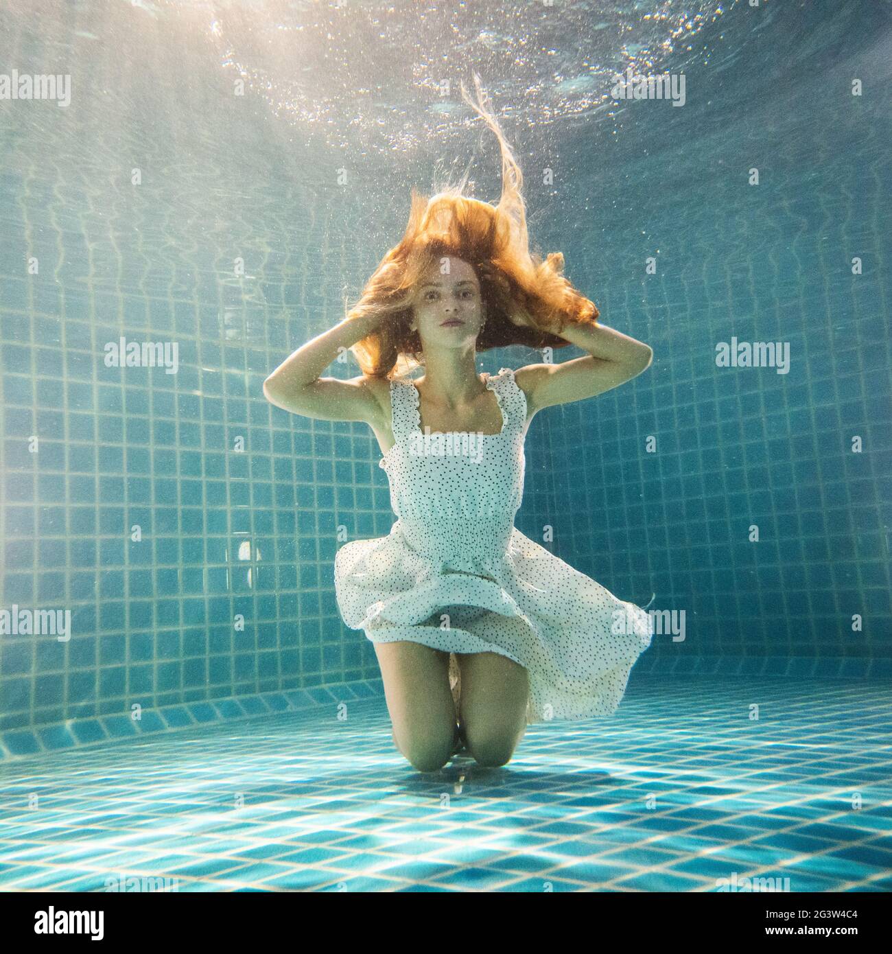 Beautiful woman underwater in white dress Stock Photo - Alamy