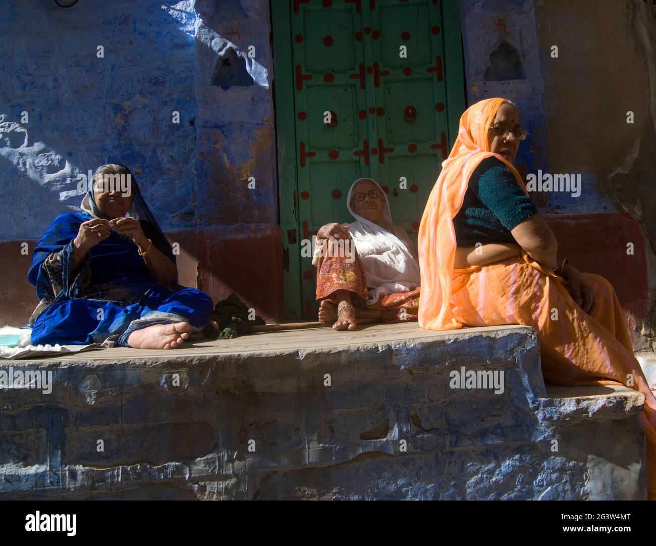A group of women on an open verandah of a blue house inside the blue city of Jodhpur, Rajasthan, India Stock Photo