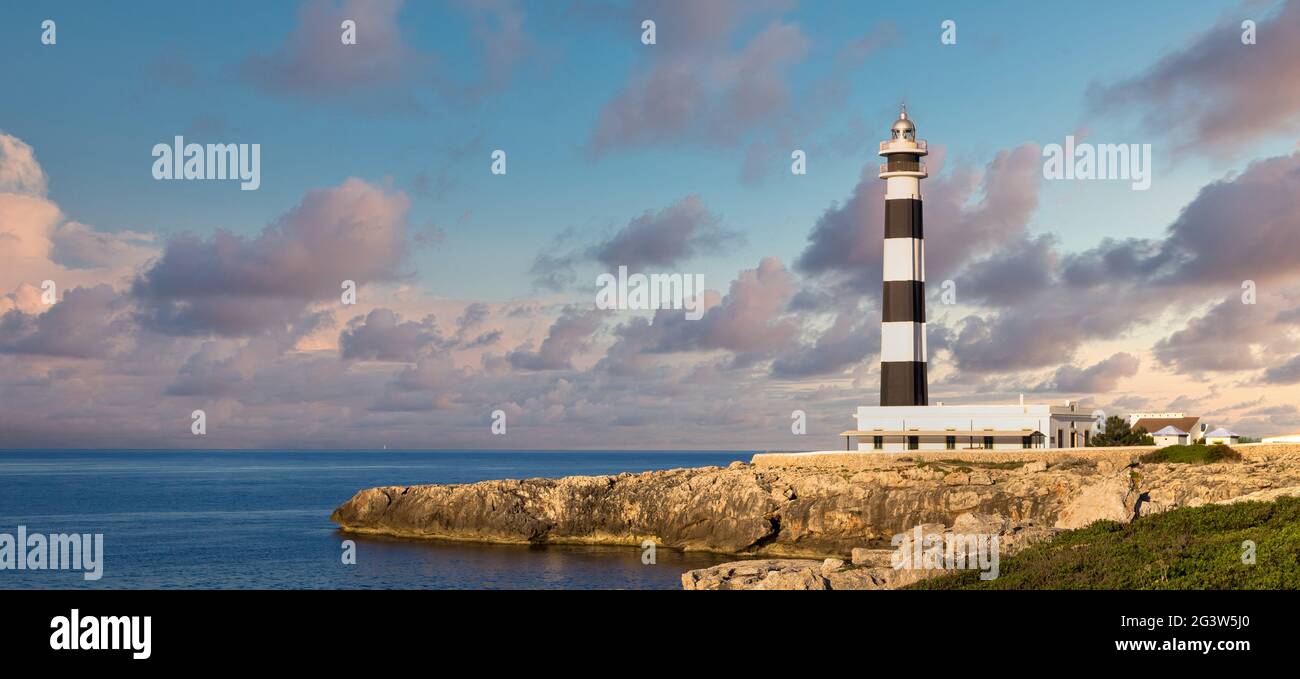 Scenic Artrutx Lighthouse at sunset in Minorca, Spain Stock Photo