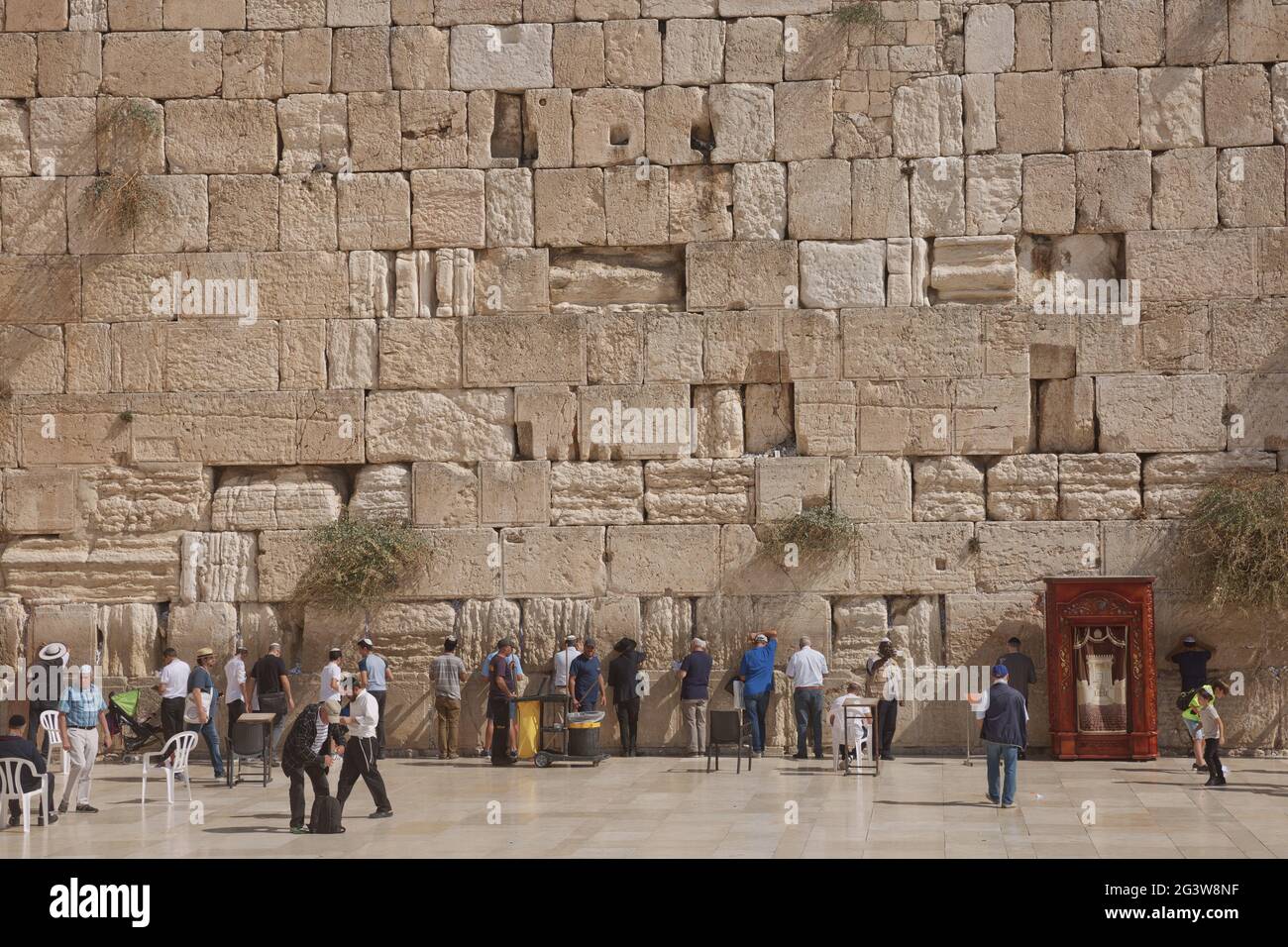 People praying at the Western 'Wailing' Wall of Ancient Temple in Jerusalem. The Wall is the most sacred place for all jews in t Stock Photo
