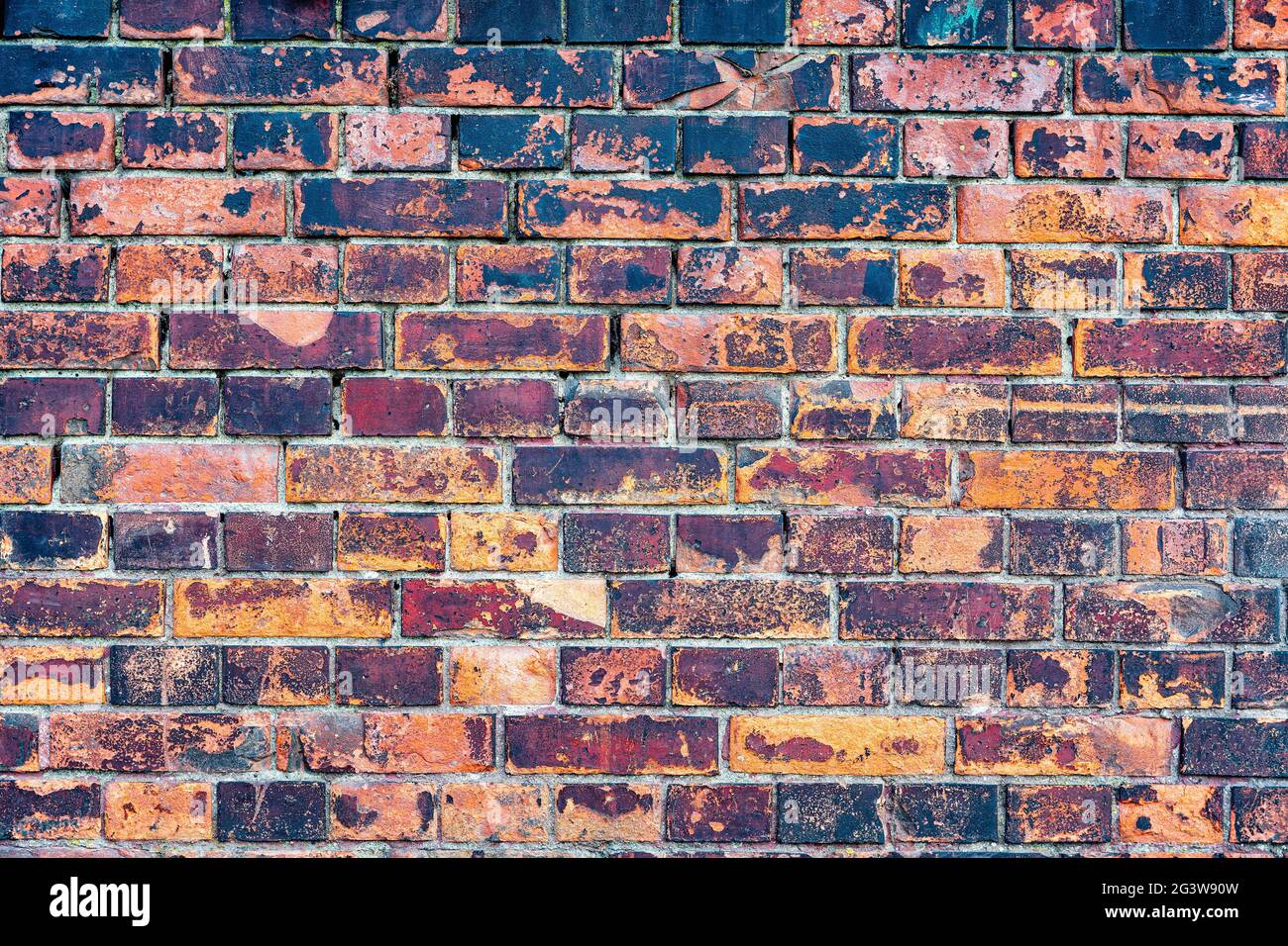 Old, rustic red corroded and damaged brick wall Stock Photo