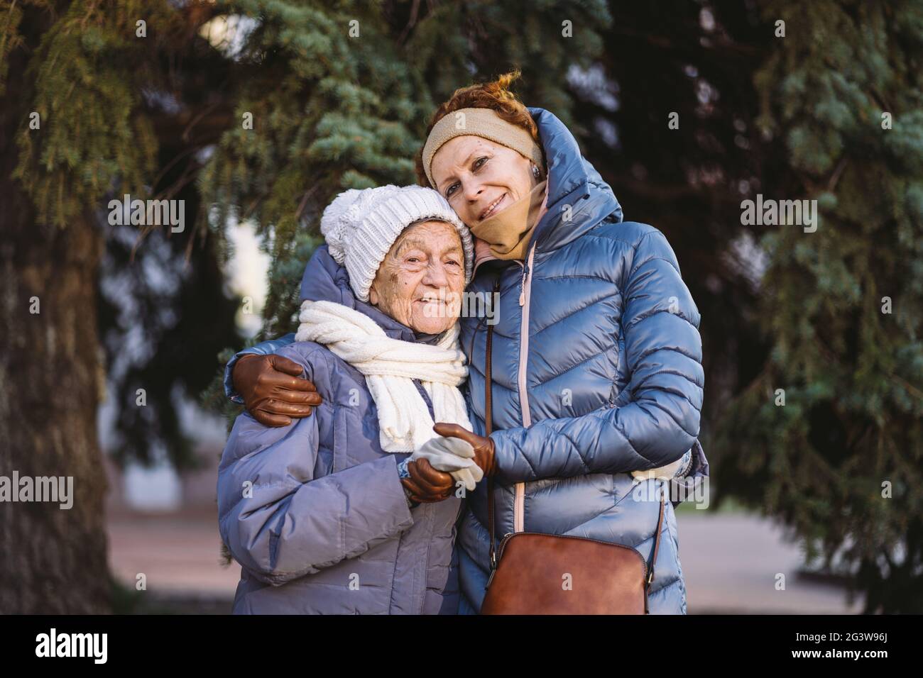 Couple of Caucasian mature woman and senior female are happy to spend time on Christmas and New Year holidays together, smiling Stock Photo