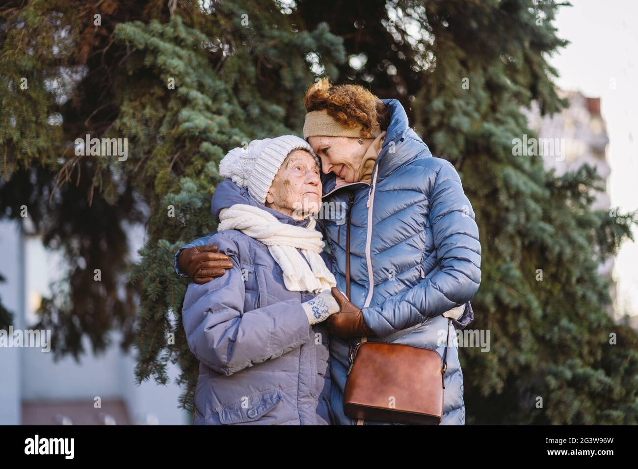 Couple of Caucasian mature woman and senior female are happy to spend time on Christmas and New Year holidays together, smiling Stock Photo