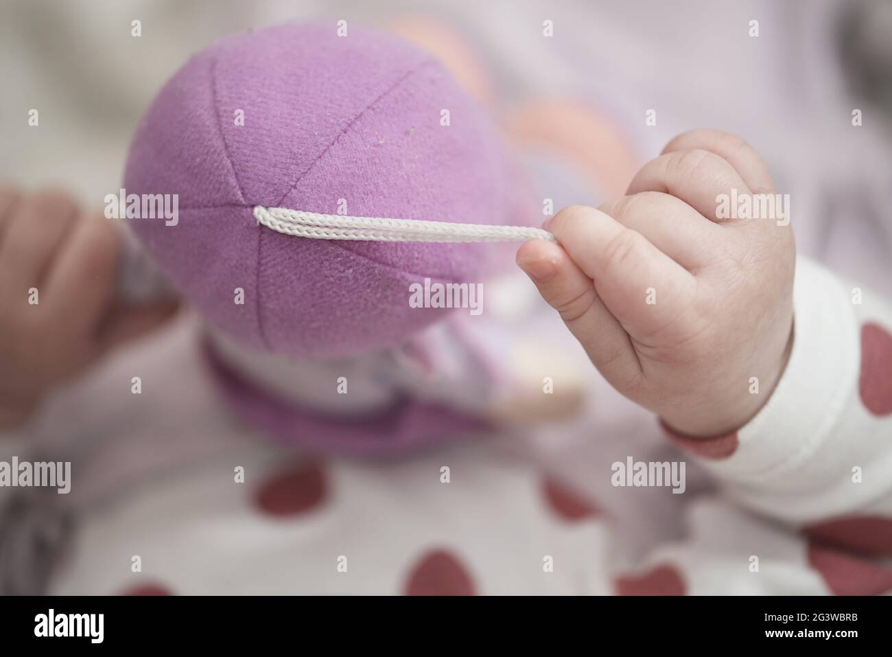 Cute little baby playing with hands and smiling Stock Photo