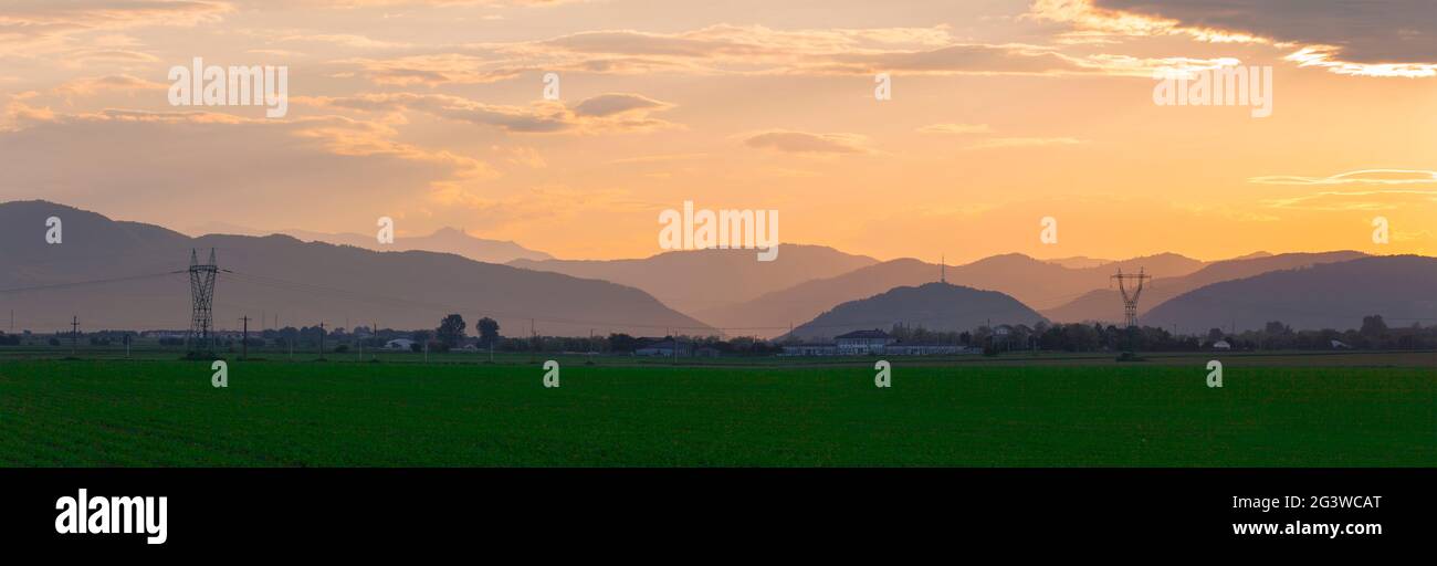 sunset landscape in Romania. Ceahlau mountain and Piatra Neamt city Stock Photo