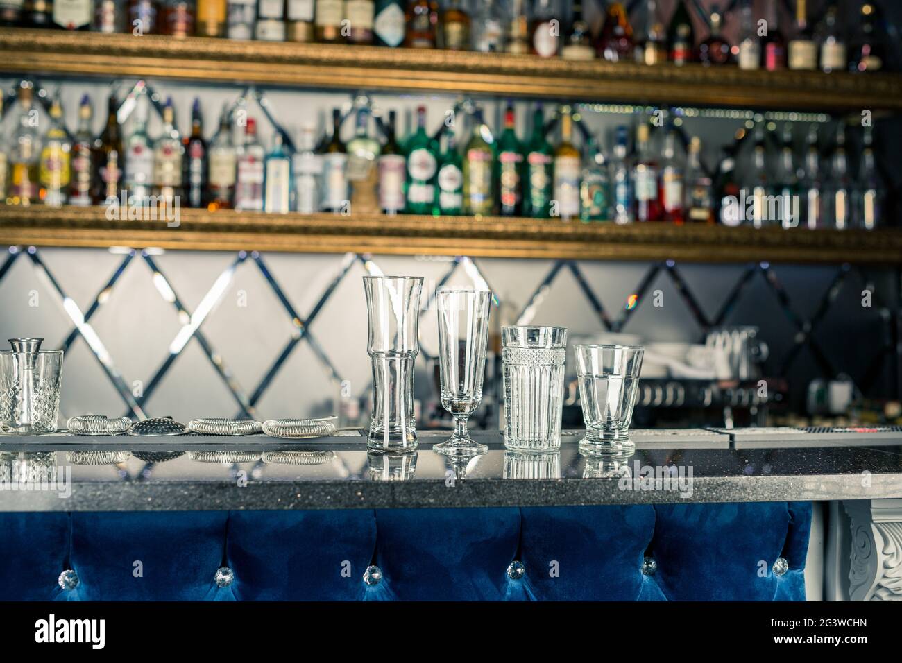 Bar counter with empty glasses. Assorted empty glasses and cocktail shots in the bar and restaurant. Glasses for alcoholic cockt Stock Photo