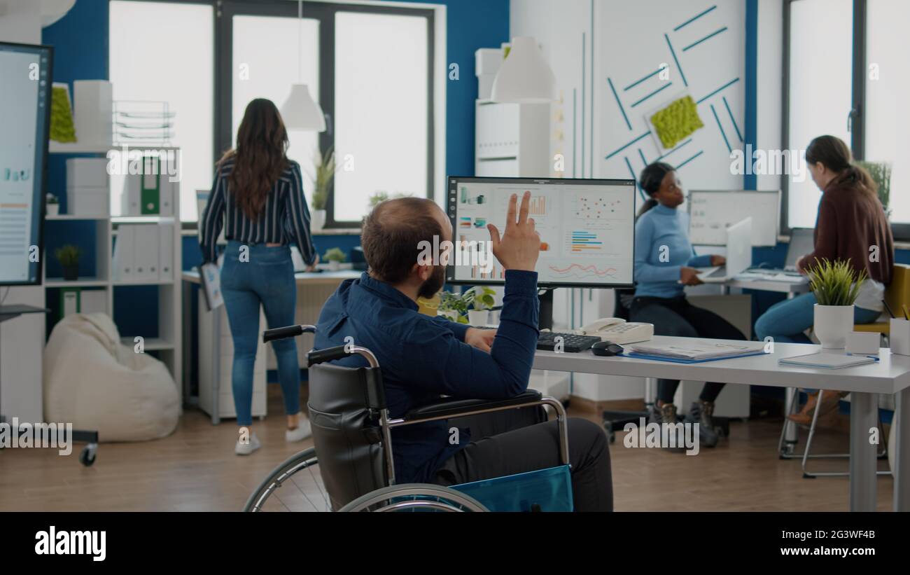 Invalid businessman and african employee working together at financial ...