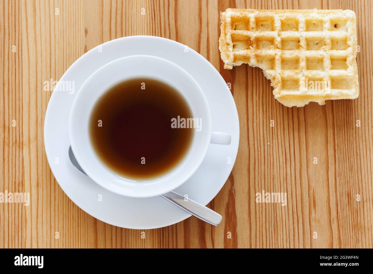 Teacup with biscuit on top right corner Stock Photo