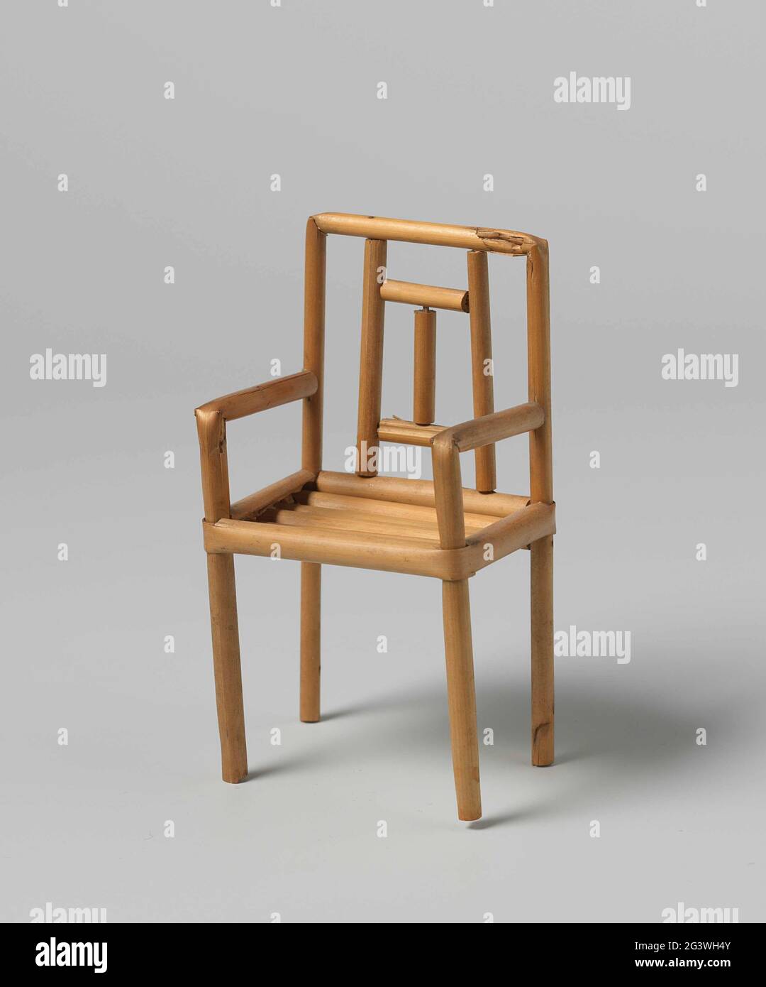 Chair of braid, with geometric motifs. Chair made from curved, and on wooden pennettes racing rod reeds. The backrest with geometric motifs. The legs interconnected with cross rules. The seat is made of 5 half reed bars confirmed in the width. Stock Photo