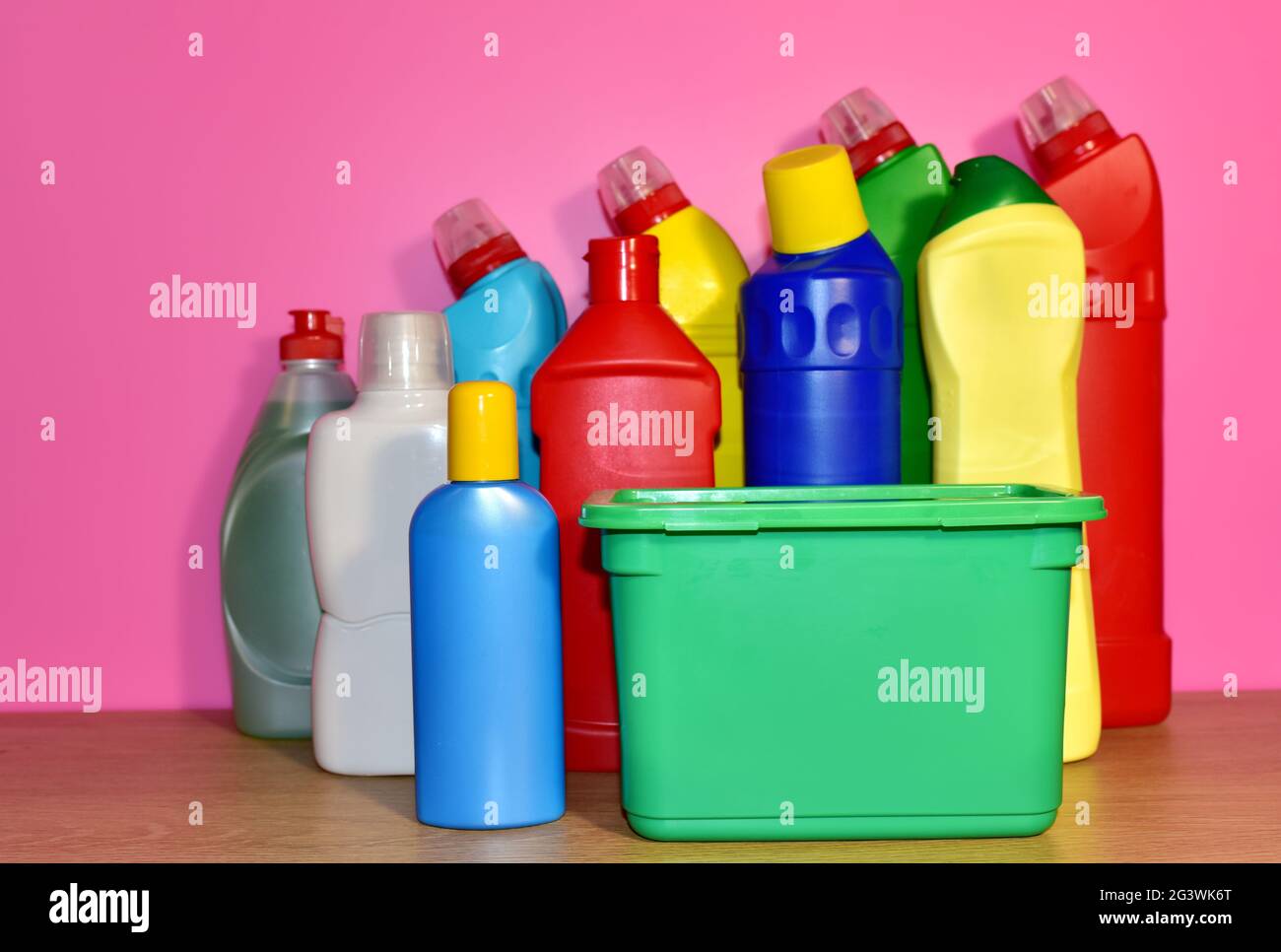 Detergent bottles on pink background. Detergents and laundry concept