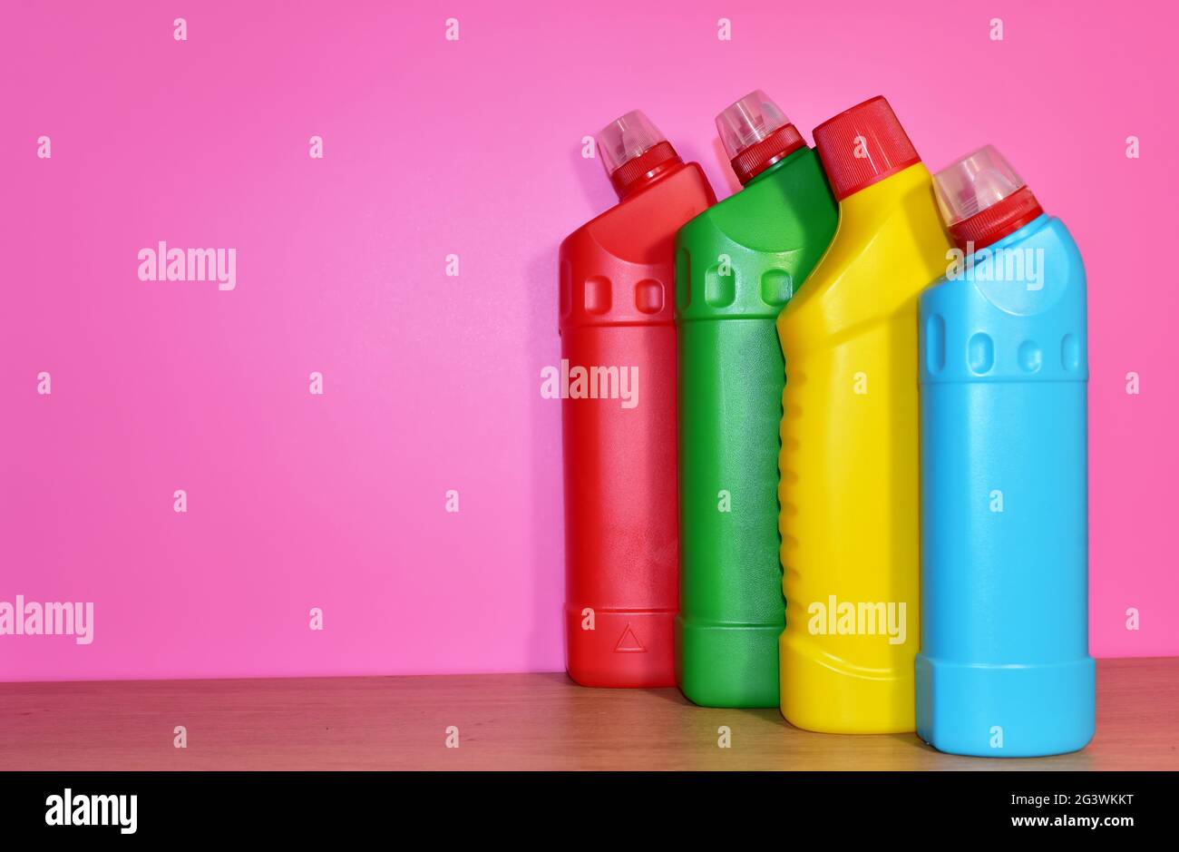 Detergent bottles on pink background. Detergents and laundry concept