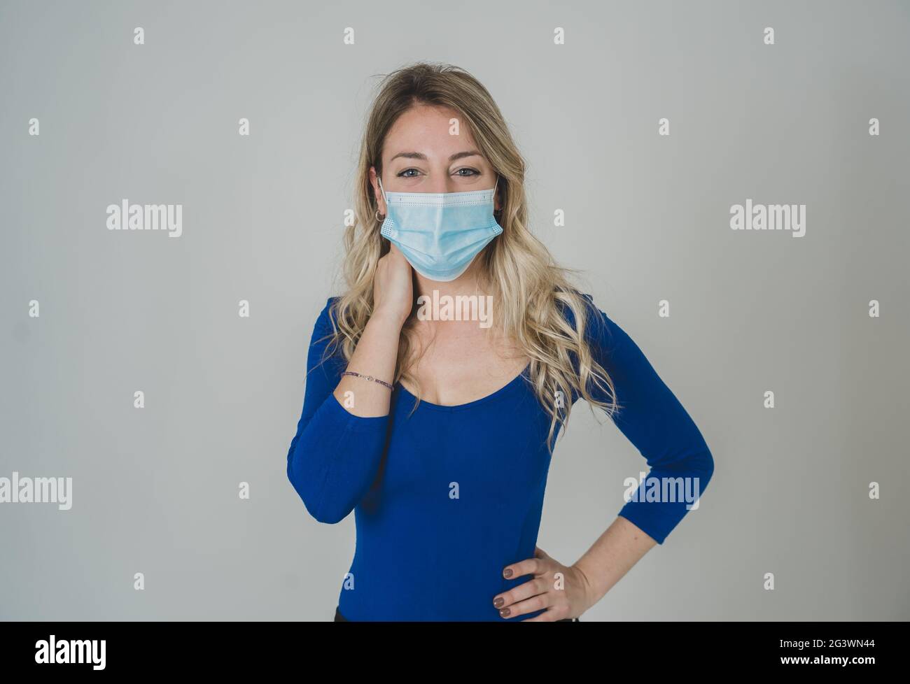 Close-up portrait of young attractive woman wearing protective medical ...