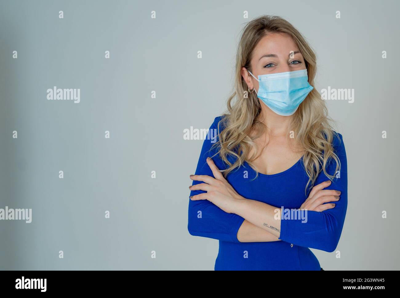 Close-up portrait of young attractive woman wearing protective medical ...