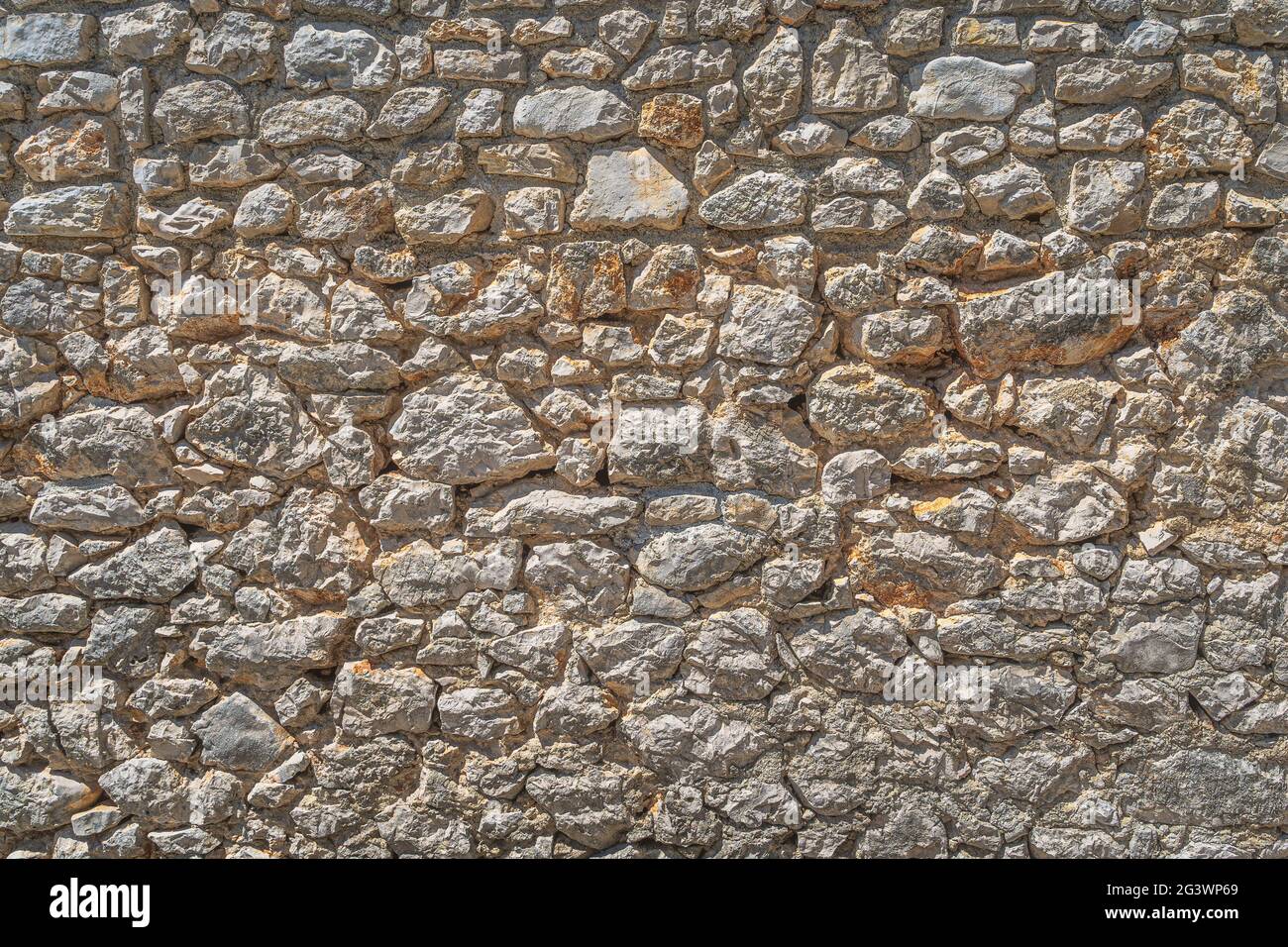 Old grungy stone or sandstone wall Stock Photo
