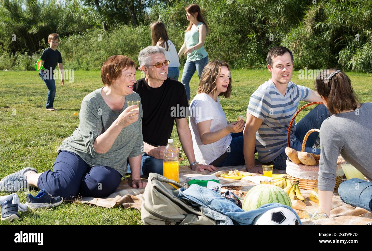 Friendly and happy family talking and eating pizza Stock Photo
