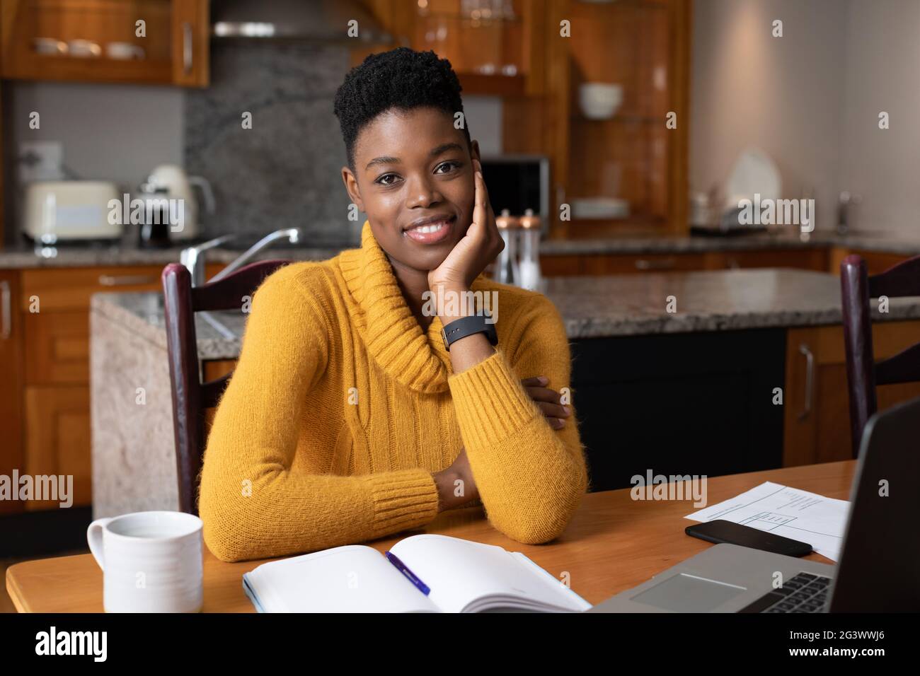 Portrait of african american woman smiling while working from home ...