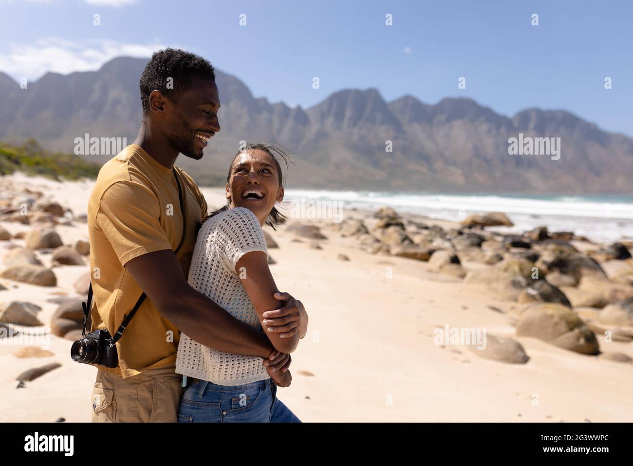 African american couple embracing on a beach by the sea Stock Photo - Alamy