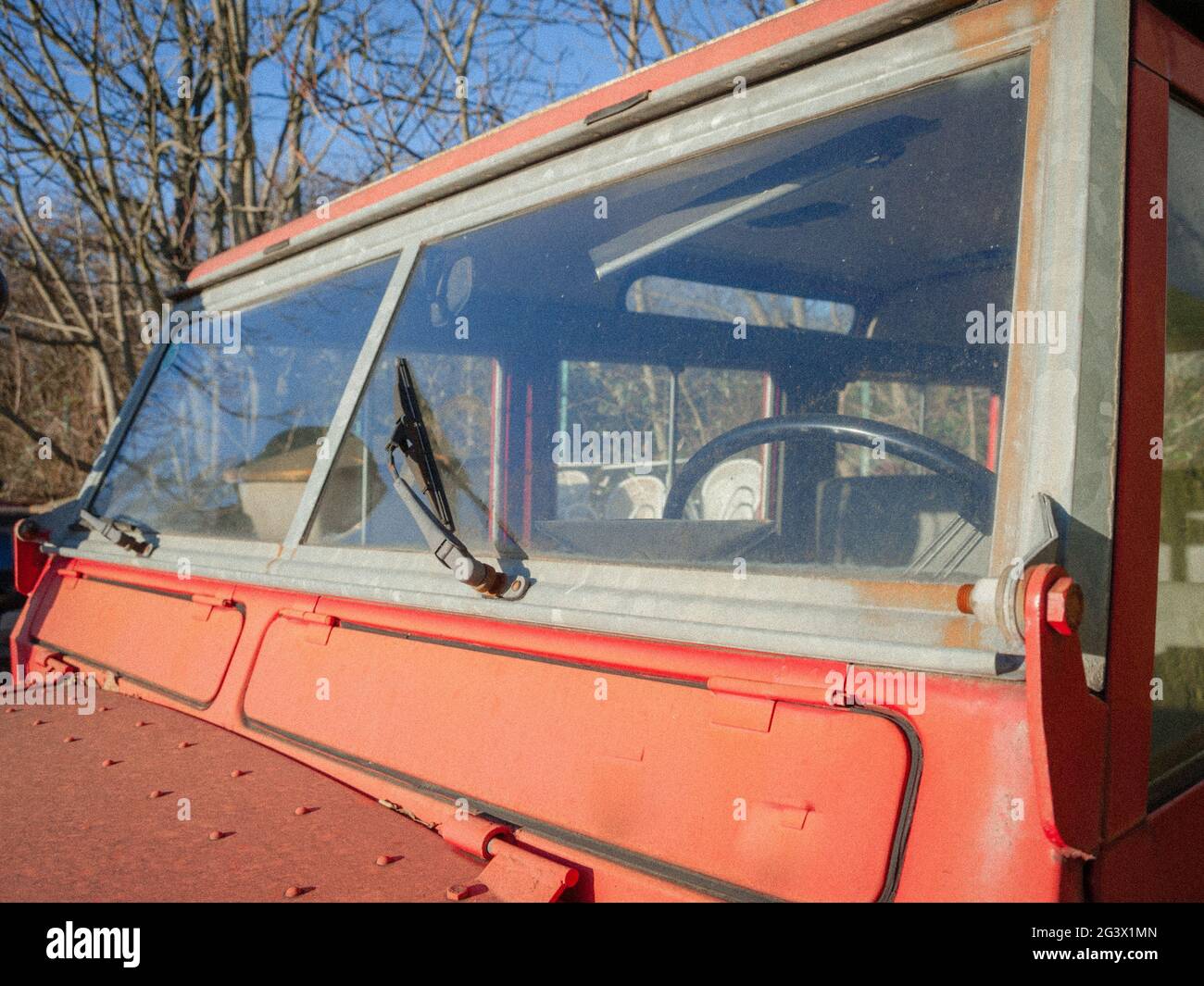 Windscreen and wiper of an old oo-road car in red colour Stock Photo