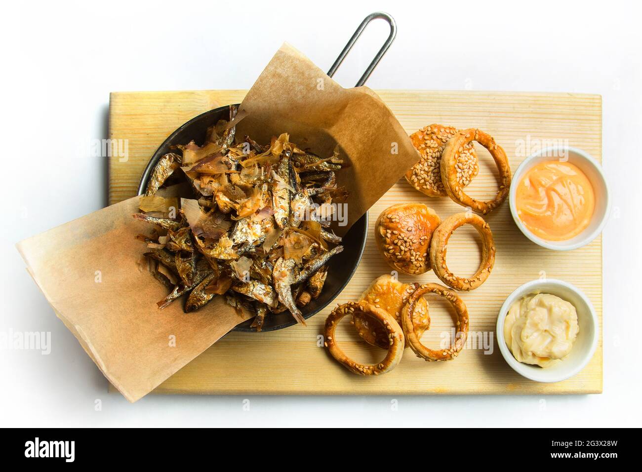 Beer snack: spicy chicken wings, cheese balls, fried black bread toast with garlic, onion rings in batter. Snack on a white back Stock Photo