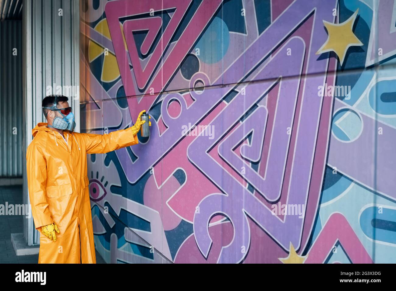 Street artist painting colorful graffiti on wall Stock Photo - Alamy