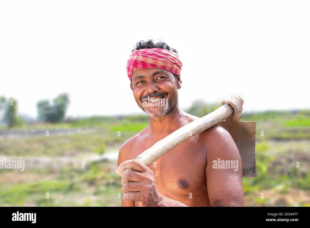 Portrait of a Farmer holding a Shovel in agricultural field Stock Photo ...