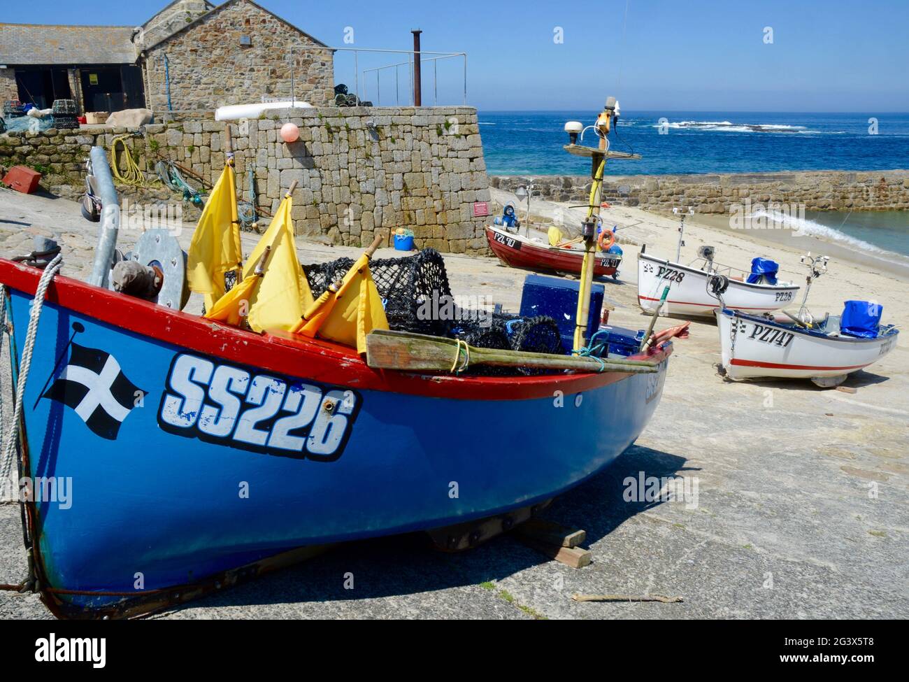 Boats  up on Sennen harbour, Cornwall, UK on sunny day Stock Photo