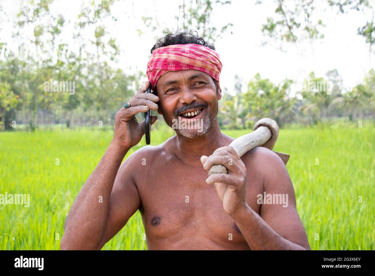 Indian farmer talking on smart phone Stock Photo