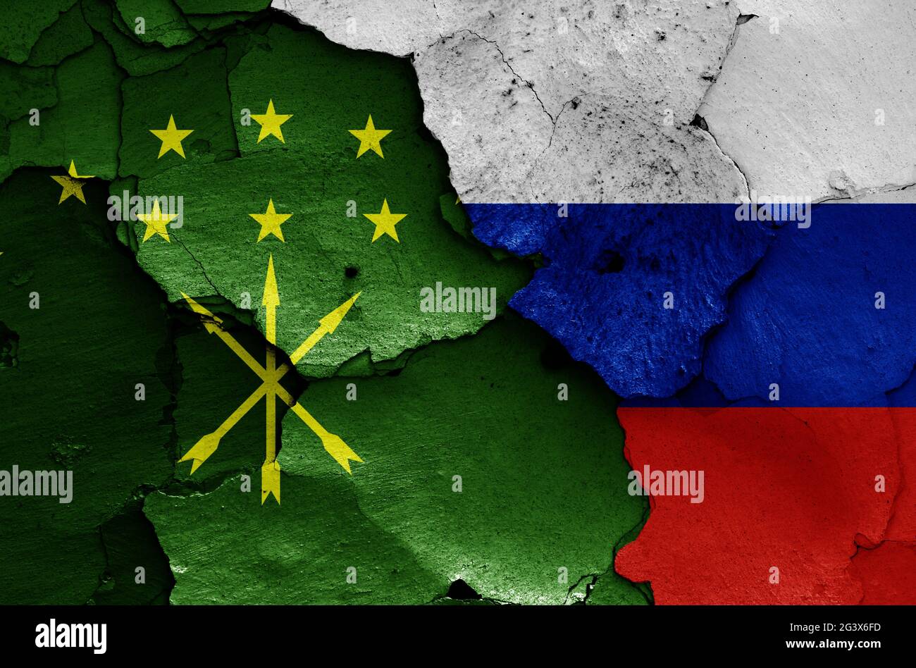 Flags of Adygea Republic and Russia painted on cracked wall Stock Photo