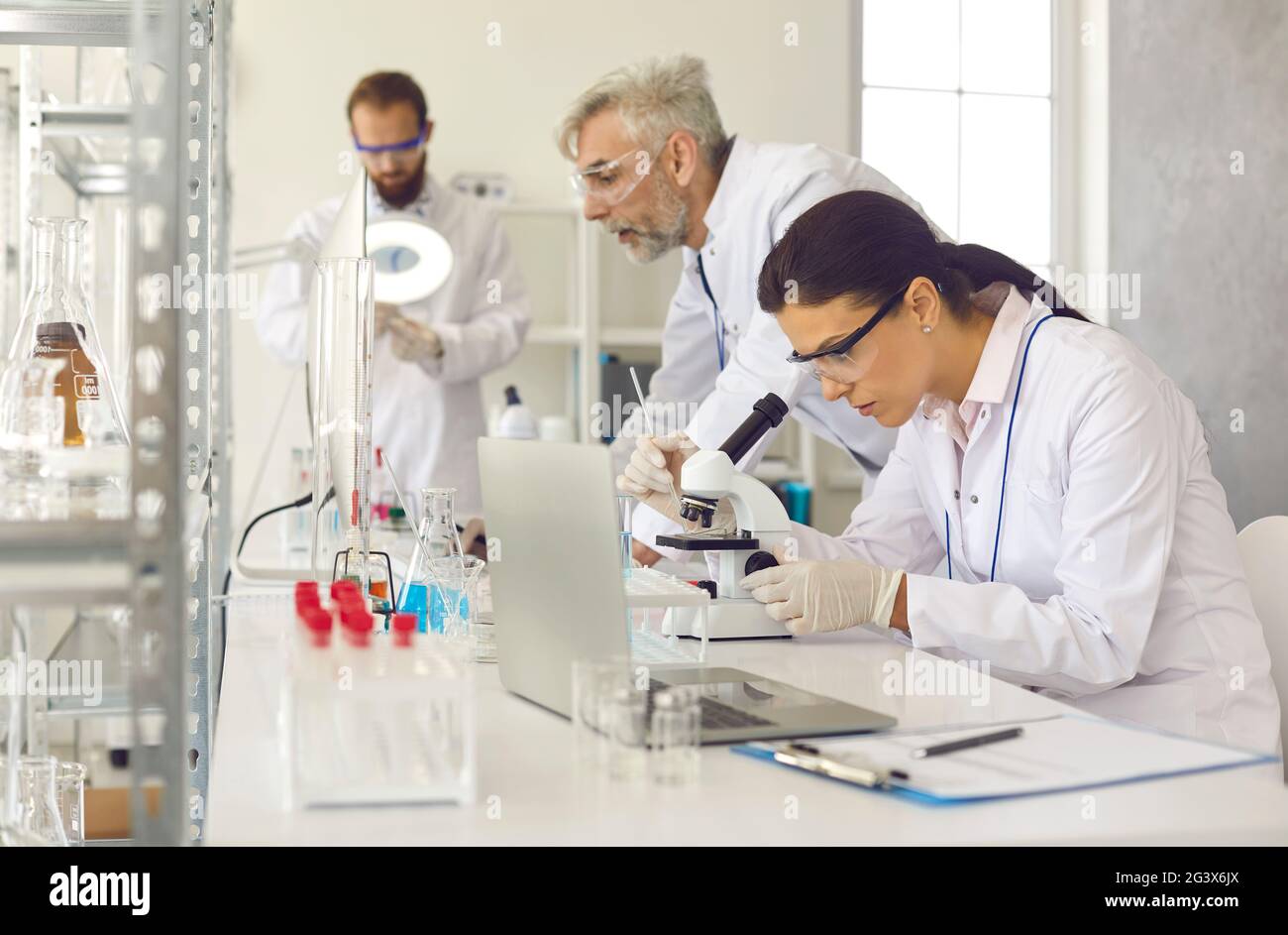 Laboratory scientist group working with lab equipment at modern